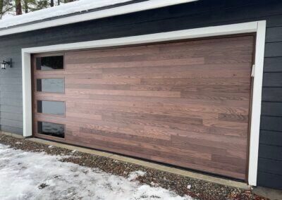 a double car garage door featuring english oak wood doors